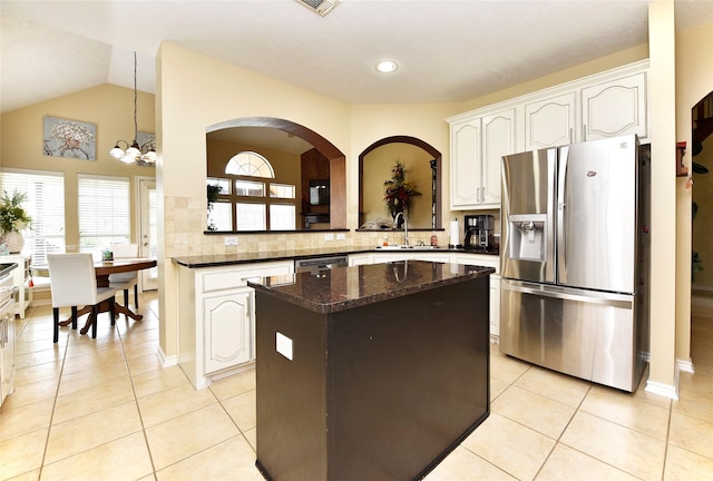 kitchen with a sink, stainless steel appliances, light tile patterned flooring, and a center island