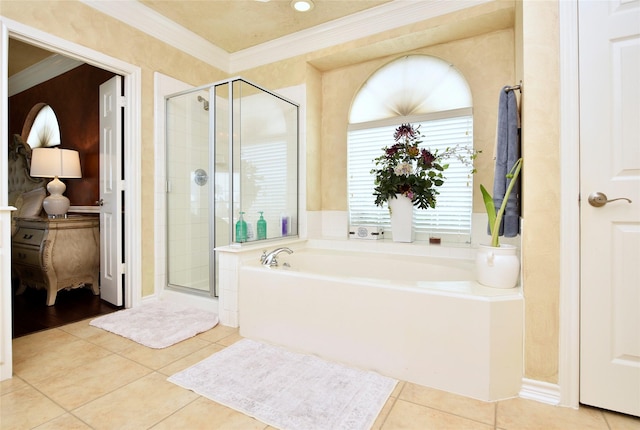 full bath featuring tile patterned flooring, a shower stall, crown molding, and a garden tub