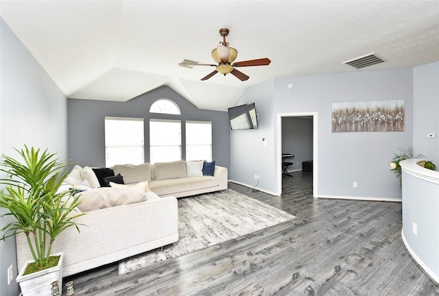 living room with visible vents, wood finished floors, baseboards, ceiling fan, and vaulted ceiling