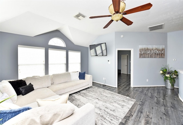 living room featuring dark wood-style floors, visible vents, baseboards, and vaulted ceiling