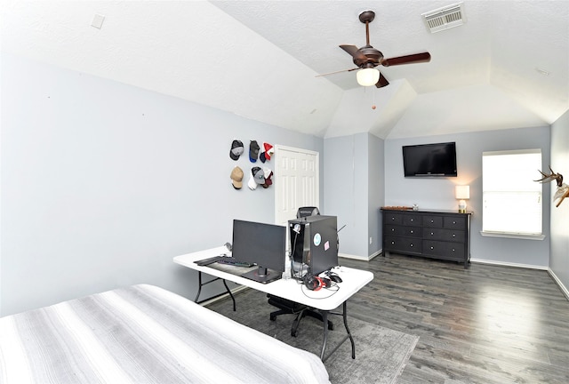 bedroom with vaulted ceiling, visible vents, baseboards, and wood finished floors