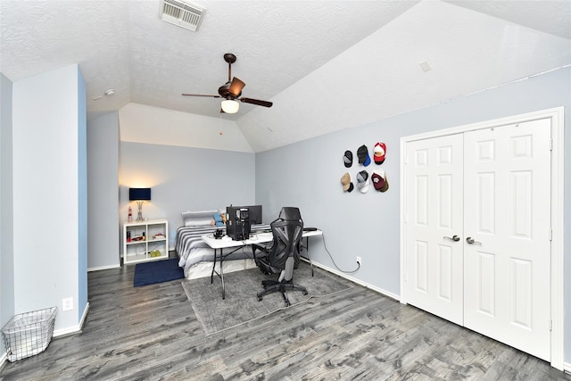 office space with visible vents, lofted ceiling, a textured ceiling, and wood finished floors