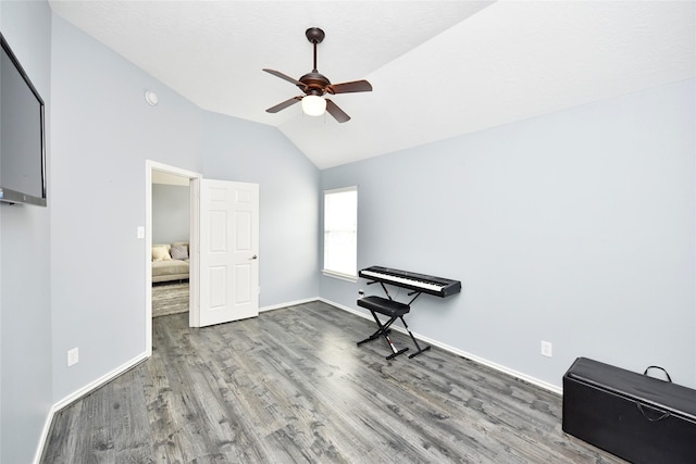 bedroom with a ceiling fan, lofted ceiling, wood finished floors, and baseboards