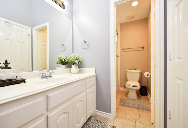 full bathroom with toilet, tile patterned flooring, a shower, baseboards, and vanity