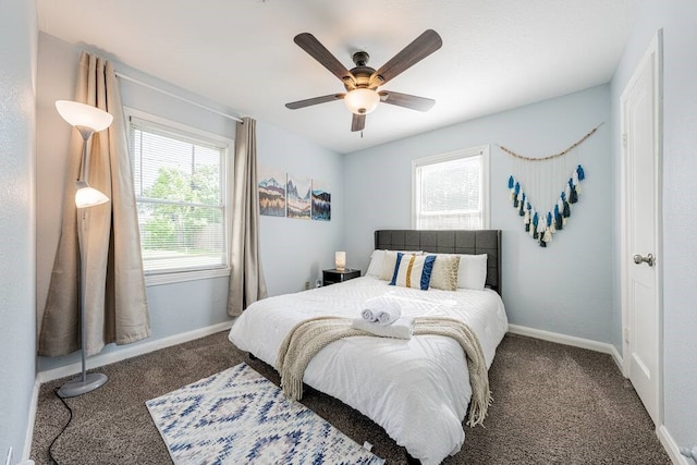 bedroom with ceiling fan, baseboards, and carpet flooring