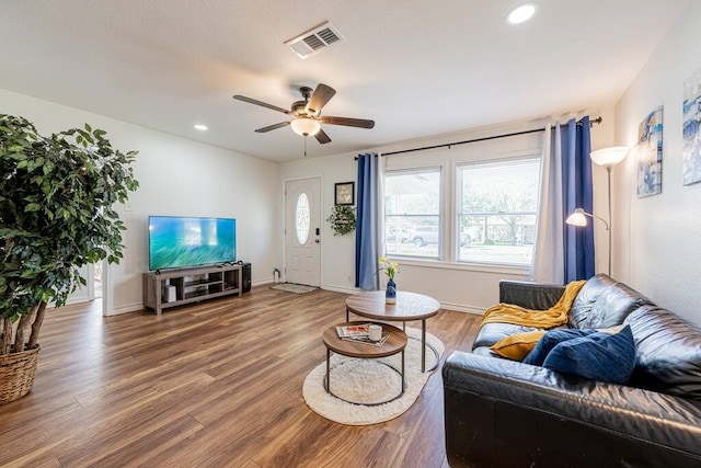 living room featuring wood finished floors, visible vents, and recessed lighting