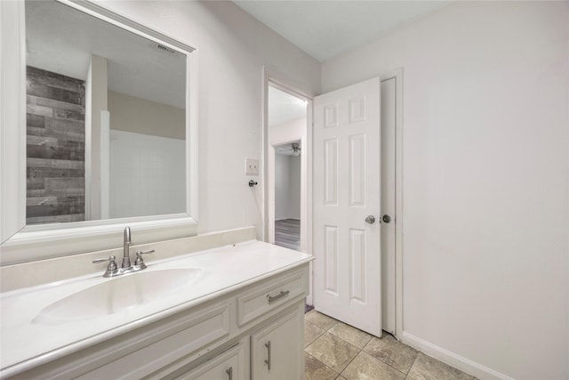 bathroom featuring vanity and baseboards