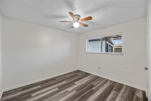 unfurnished room with a textured ceiling, ceiling fan, dark wood-style flooring, and baseboards