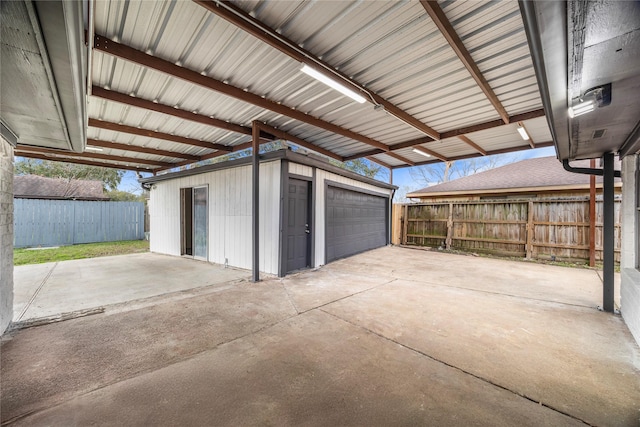 detached garage featuring fence