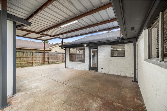 view of patio with fence and visible vents