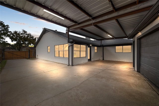 exterior space with a garage, fence, and a gate