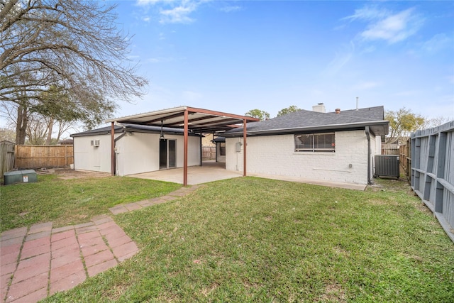 back of property with brick siding, a patio area, a fenced backyard, and cooling unit