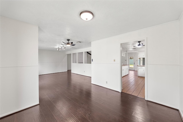 empty room with ceiling fan and wood finished floors