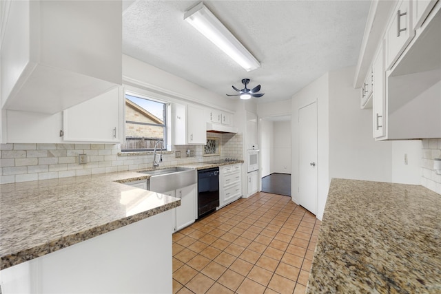 kitchen with ceiling fan, black dishwasher, white cabinetry, and decorative backsplash