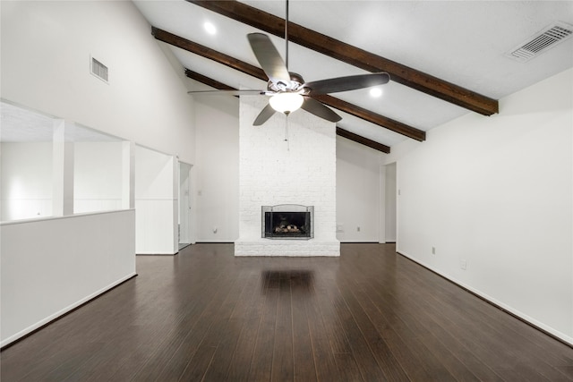 unfurnished living room featuring ceiling fan, a fireplace, wood finished floors, and visible vents