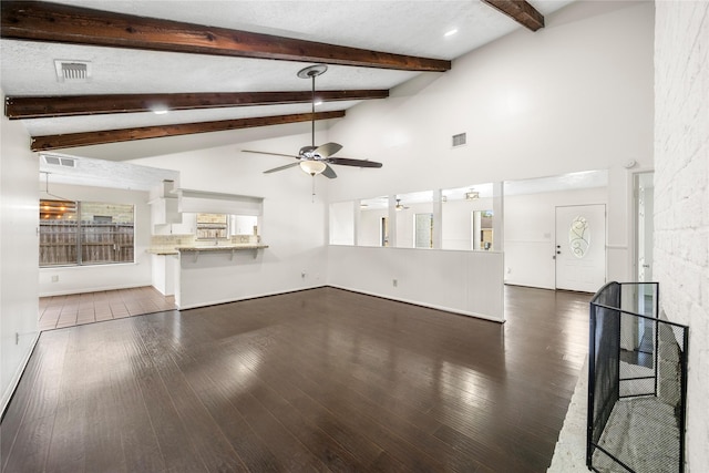 unfurnished living room with high vaulted ceiling, visible vents, dark wood finished floors, and ceiling fan