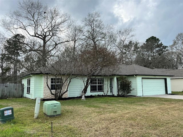 view of front facade featuring a garage, fence, driveway, and a front lawn