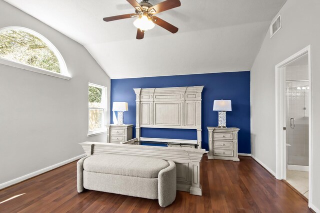 bedroom featuring baseboards, visible vents, lofted ceiling, dark wood-style flooring, and ensuite bathroom