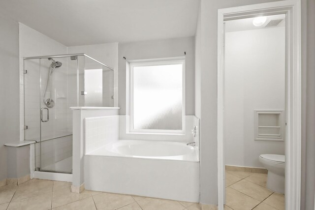 full bath featuring tile patterned flooring, a shower stall, a garden tub, and toilet