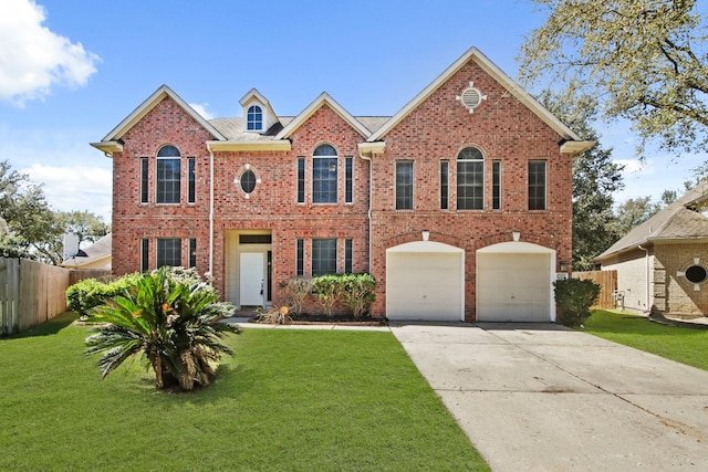 colonial home with a front yard, fence, brick siding, and driveway