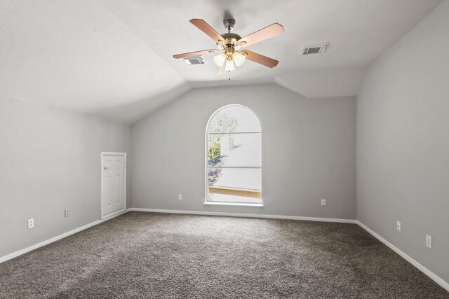 additional living space with vaulted ceiling, visible vents, carpet floors, and ceiling fan