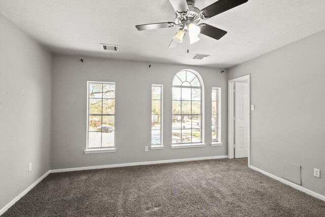 unfurnished room featuring baseboards, visible vents, carpet floors, and ceiling fan