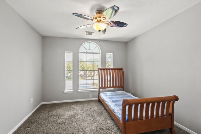 carpeted bedroom featuring baseboards, visible vents, and ceiling fan