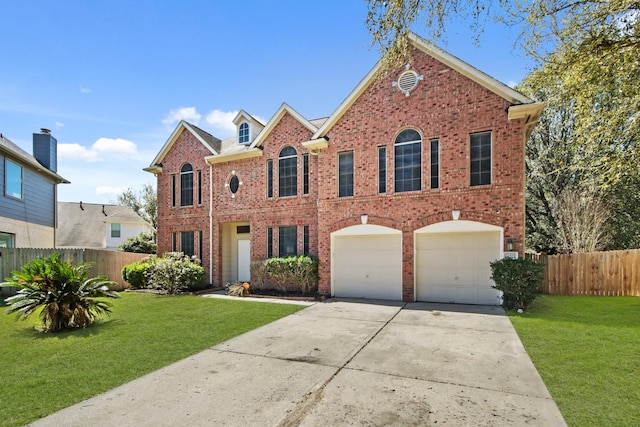 colonial inspired home with brick siding, concrete driveway, a front yard, and fence