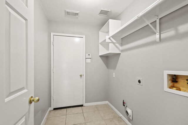 washroom featuring light tile patterned flooring, laundry area, hookup for a washing machine, and visible vents