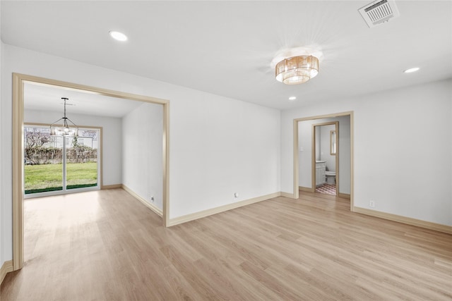 empty room with baseboards, visible vents, an inviting chandelier, recessed lighting, and light wood-type flooring