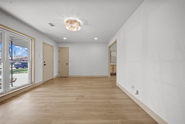 unfurnished room with visible vents, recessed lighting, baseboards, and light wood-style floors