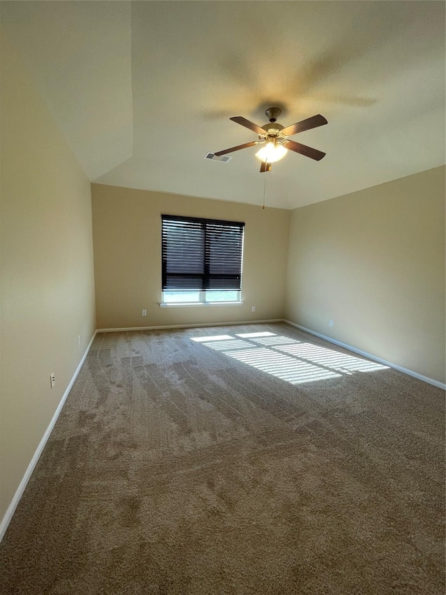 unfurnished room with ceiling fan, carpet, visible vents, and baseboards