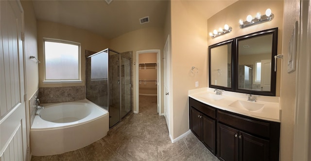 full bathroom featuring a stall shower, visible vents, a sink, and a spacious closet