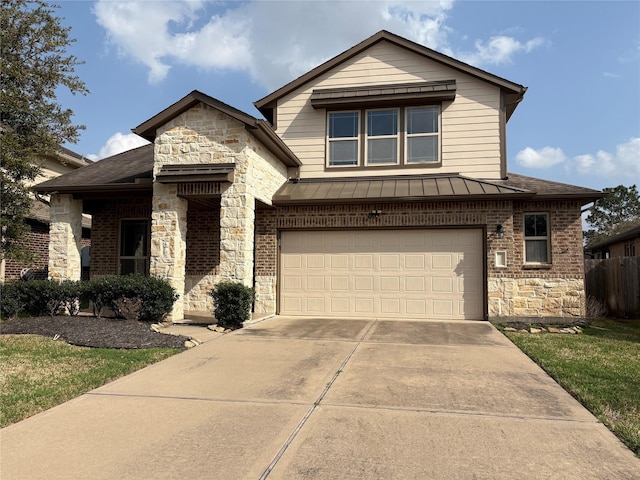 view of front of home featuring metal roof, an attached garage, stone siding, concrete driveway, and a standing seam roof