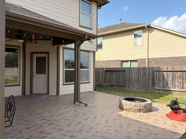 view of patio / terrace featuring fence, a fire pit, and ceiling fan