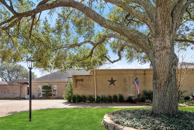 view of front of home featuring a front yard and brick siding