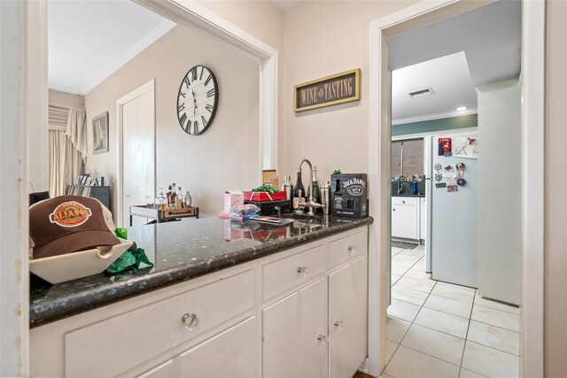 2526 Country Club Blvd, Sugar Land, TX 77478 - bar area featuring ornamental molding, freestanding refrigerator, light tile patterned flooring, and a sink