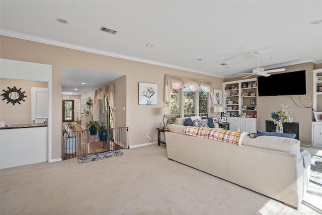 carpeted living room featuring baseboards, visible vents, ceiling fan, crown molding, and a fireplace