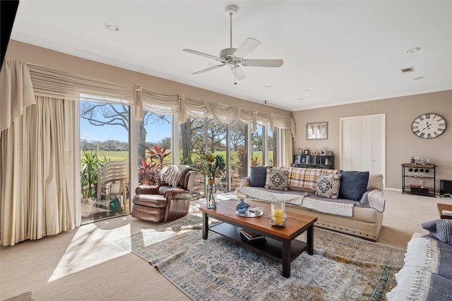 living room with light carpet, ornamental molding, visible vents, and a wealth of natural light