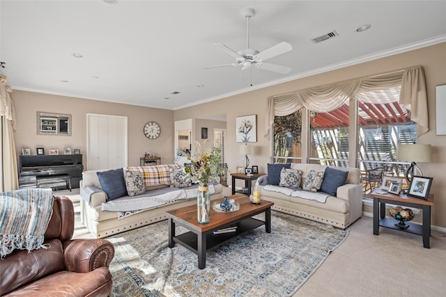 carpeted living room with a ceiling fan, visible vents, and crown molding