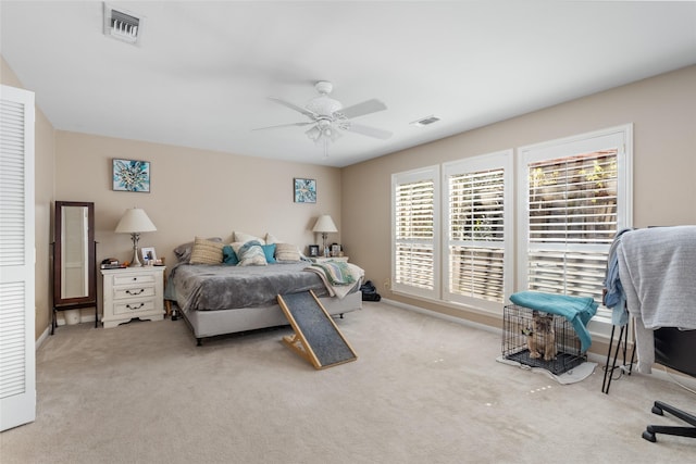 carpeted bedroom with ceiling fan, visible vents, and baseboards