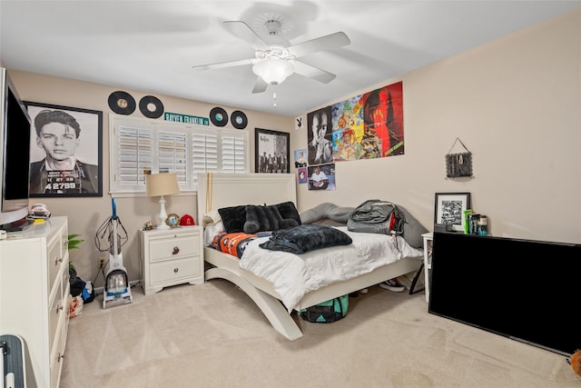 bedroom featuring light carpet and ceiling fan