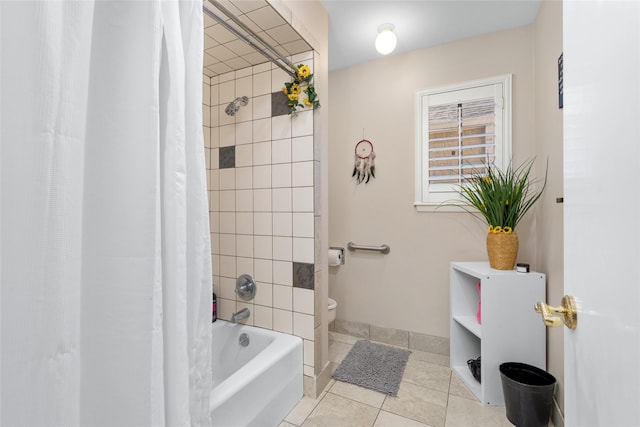 bathroom featuring tile patterned flooring, baseboards, shower / tub combo with curtain, and toilet