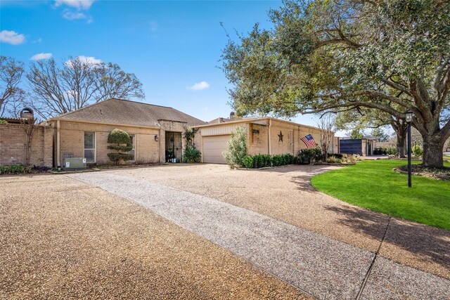 2526 Country Club Blvd, Sugar Land, TX 77478 - view of front facade with driveway, a garage, and brick siding