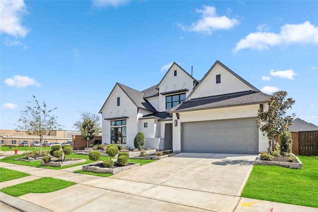 view of front of home with a shingled roof, a front lawn, fence, driveway, and an attached garage