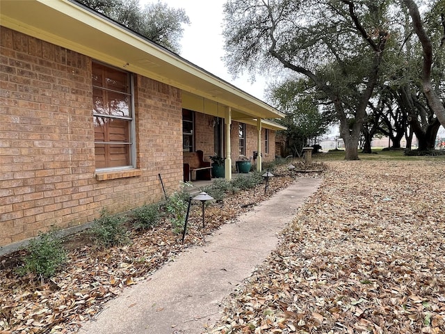 view of property exterior with brick siding