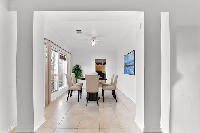 dining room with light tile patterned flooring, baseboards, and ceiling fan