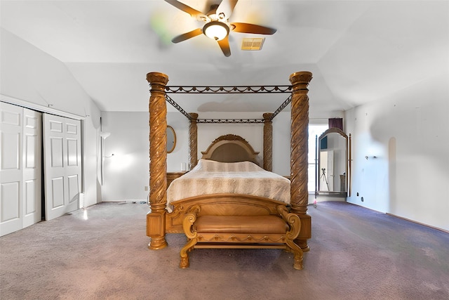 carpeted bedroom featuring visible vents, a closet, a ceiling fan, and vaulted ceiling