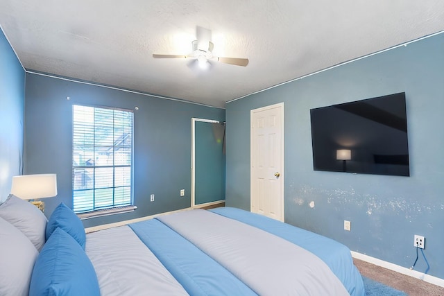 carpeted bedroom with baseboards, a textured ceiling, and ceiling fan