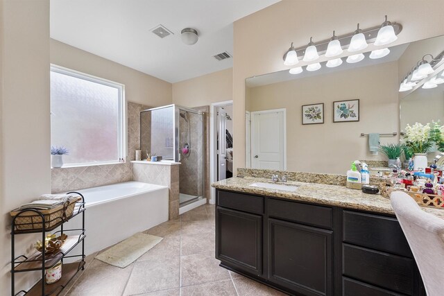 full bathroom with tile patterned flooring, visible vents, a stall shower, a bath, and vanity